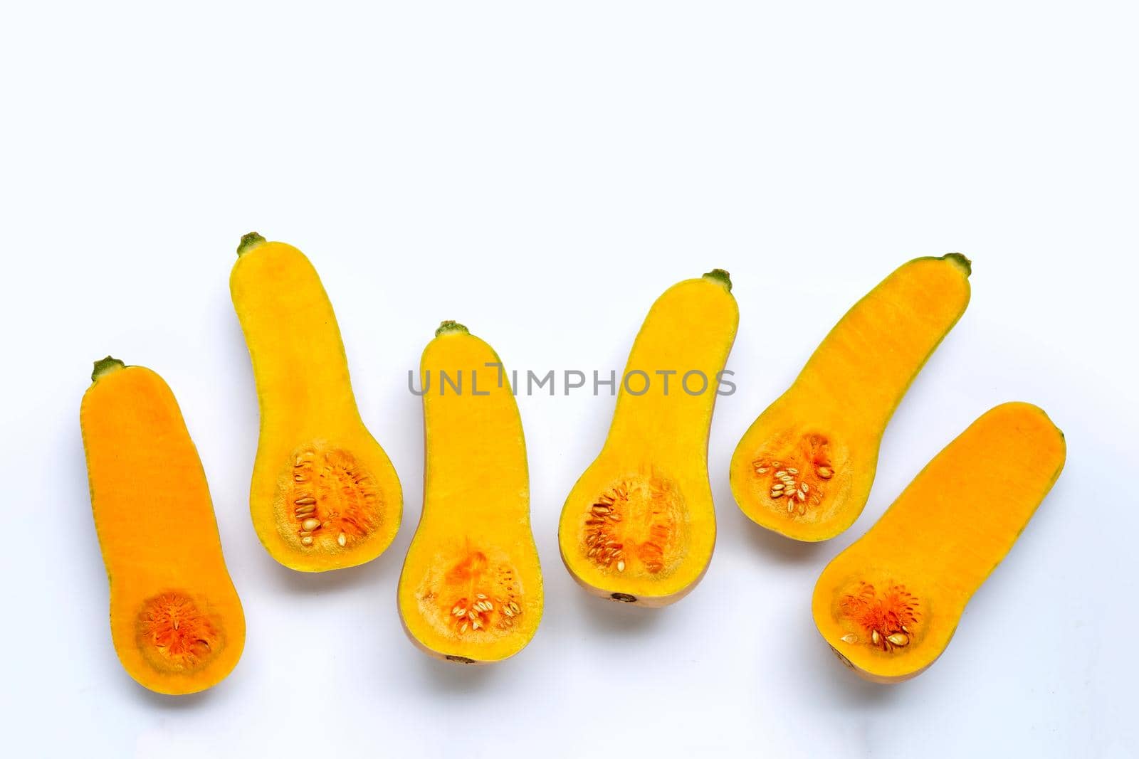Cut and slices butternut squash on white background.