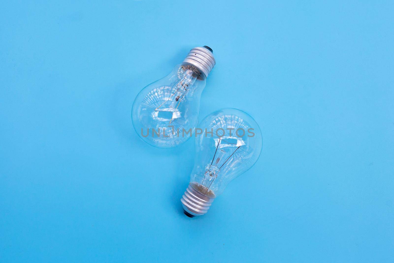 Light bulbs on blue background. Ideas and creative thinking concept. Top view