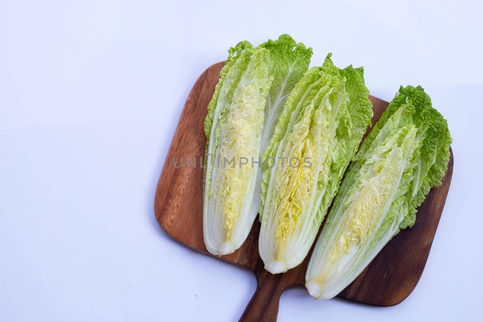 Chinese cabbage on cutting board on white background. Copy space
