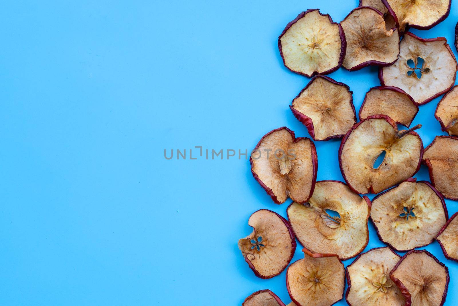 Dried apple slices on blue background