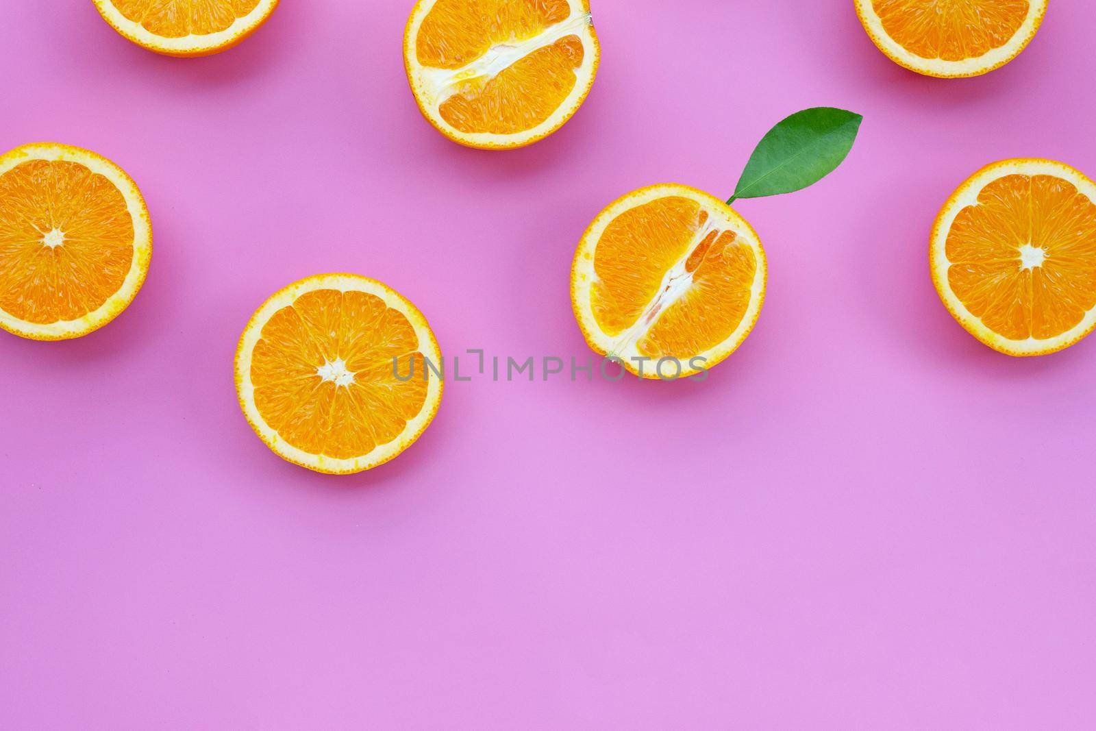 High vitamin C, Juicy and sweet. Fresh orange fruit on pink background.