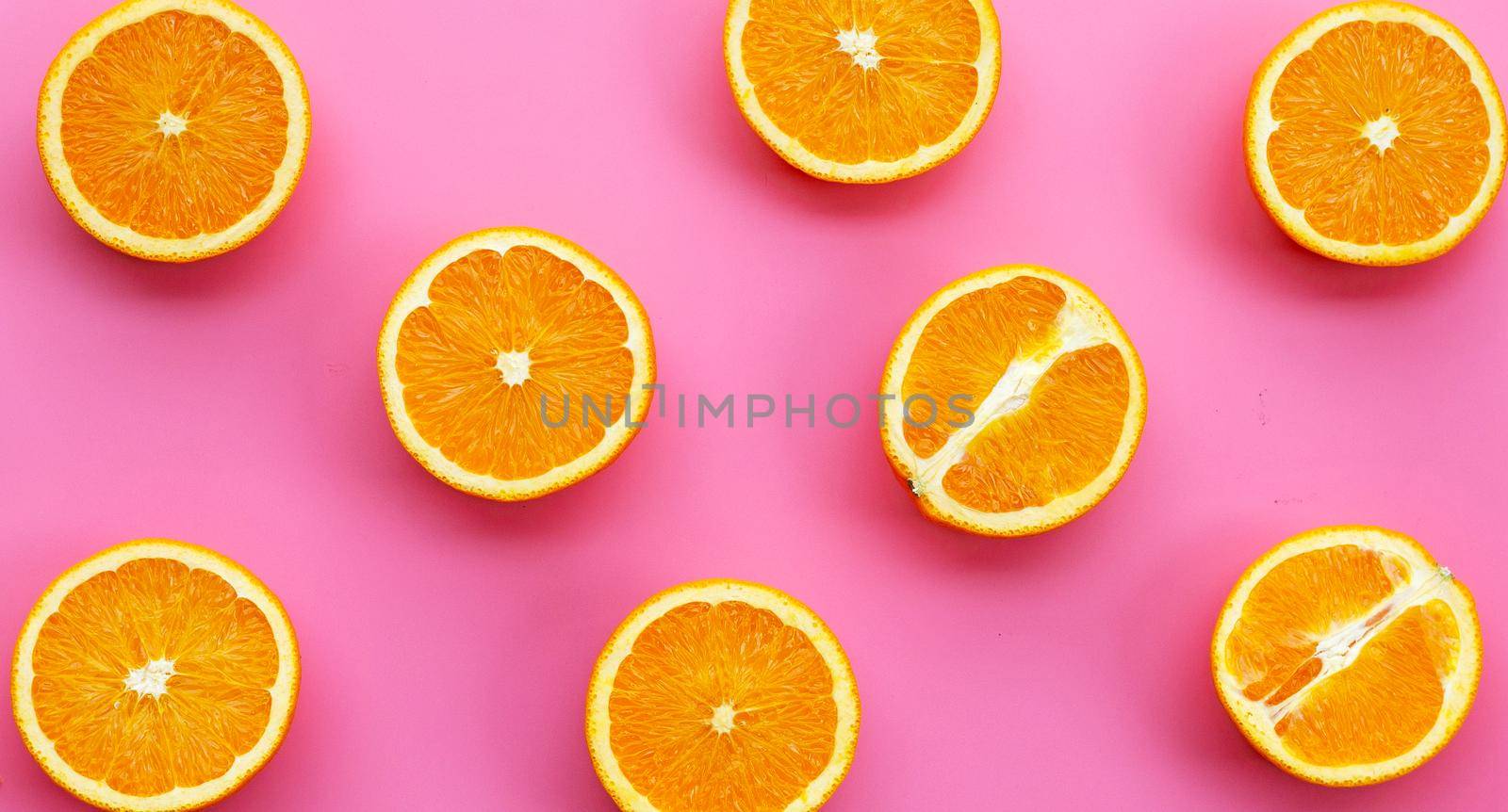 High vitamin C, Juicy and sweet. Fresh orange fruit on pink background.