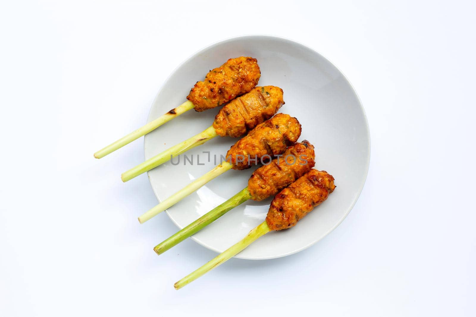 Grilled minced chicken with curry paste and coconut cream on lemongrass skewers. Top view