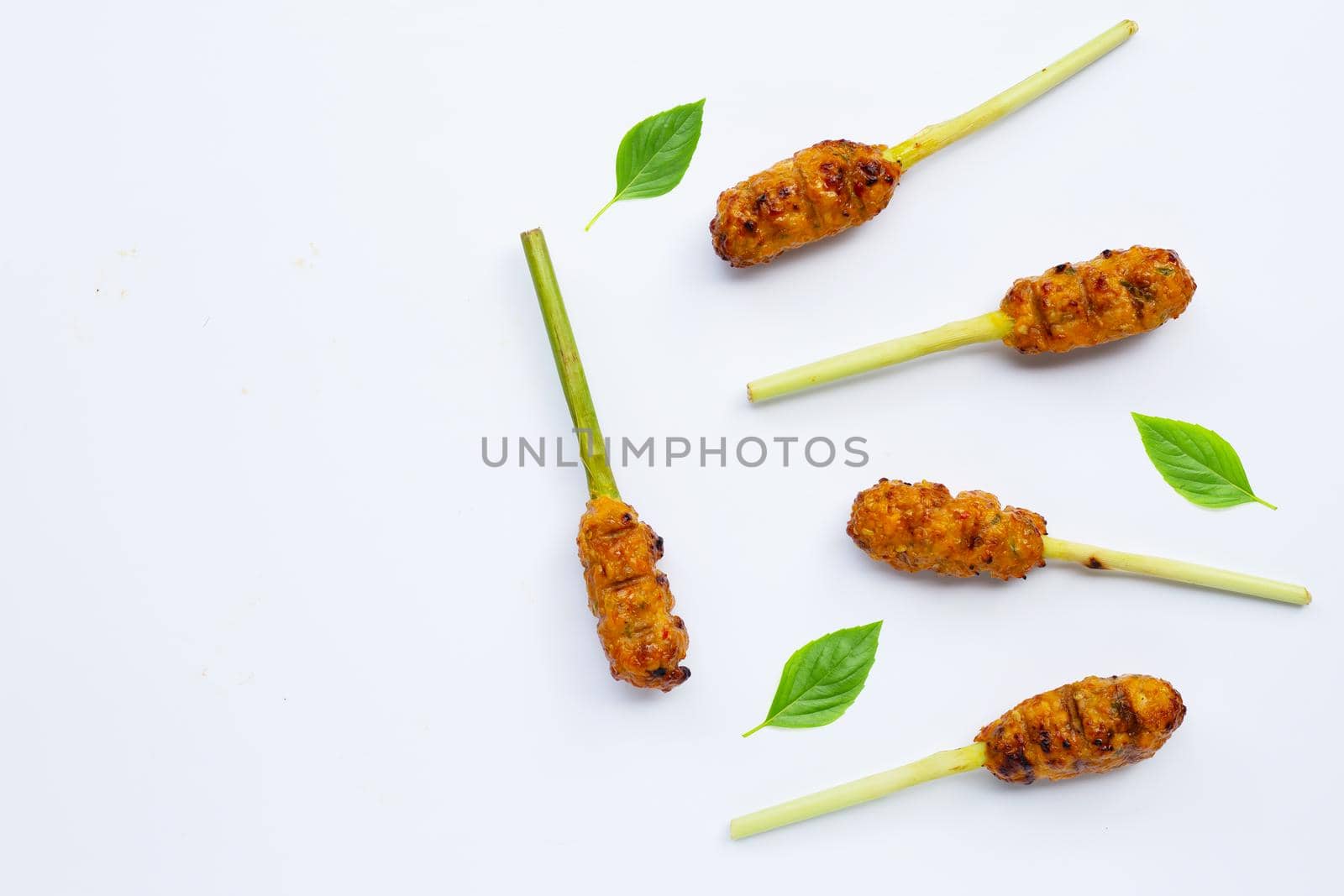 Grilled minced chicken with curry paste and coconut cream on lemongrass skewers. Top view