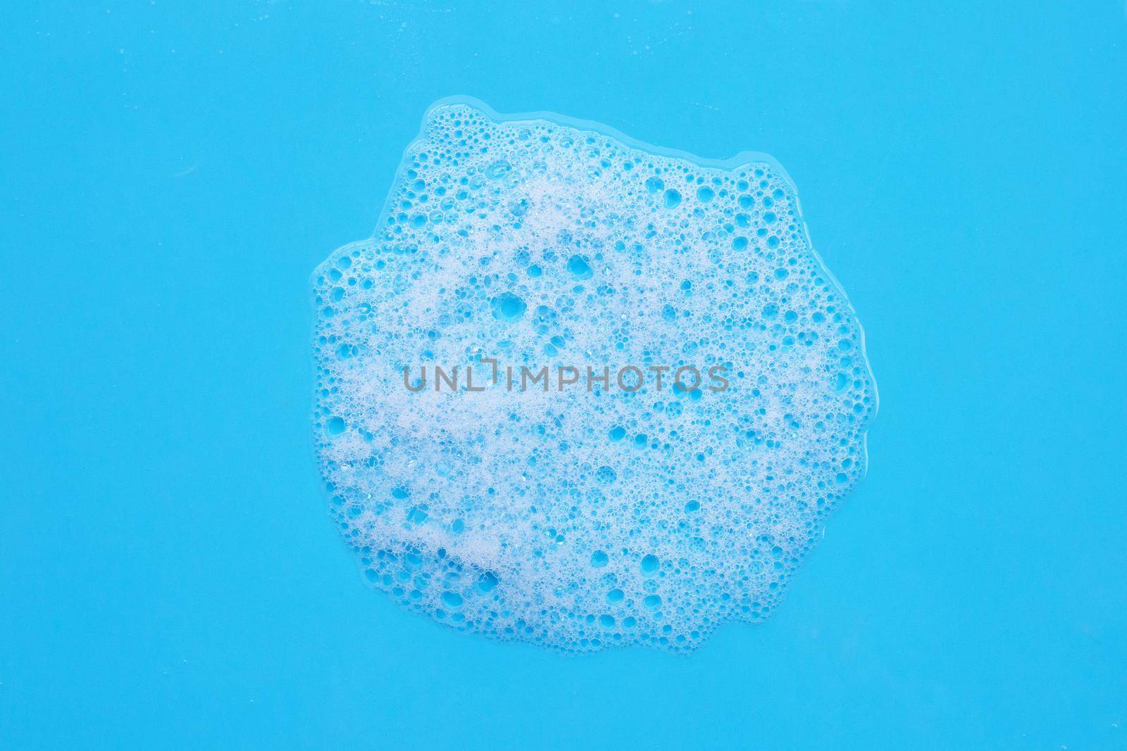 Foam on blue background. Top view