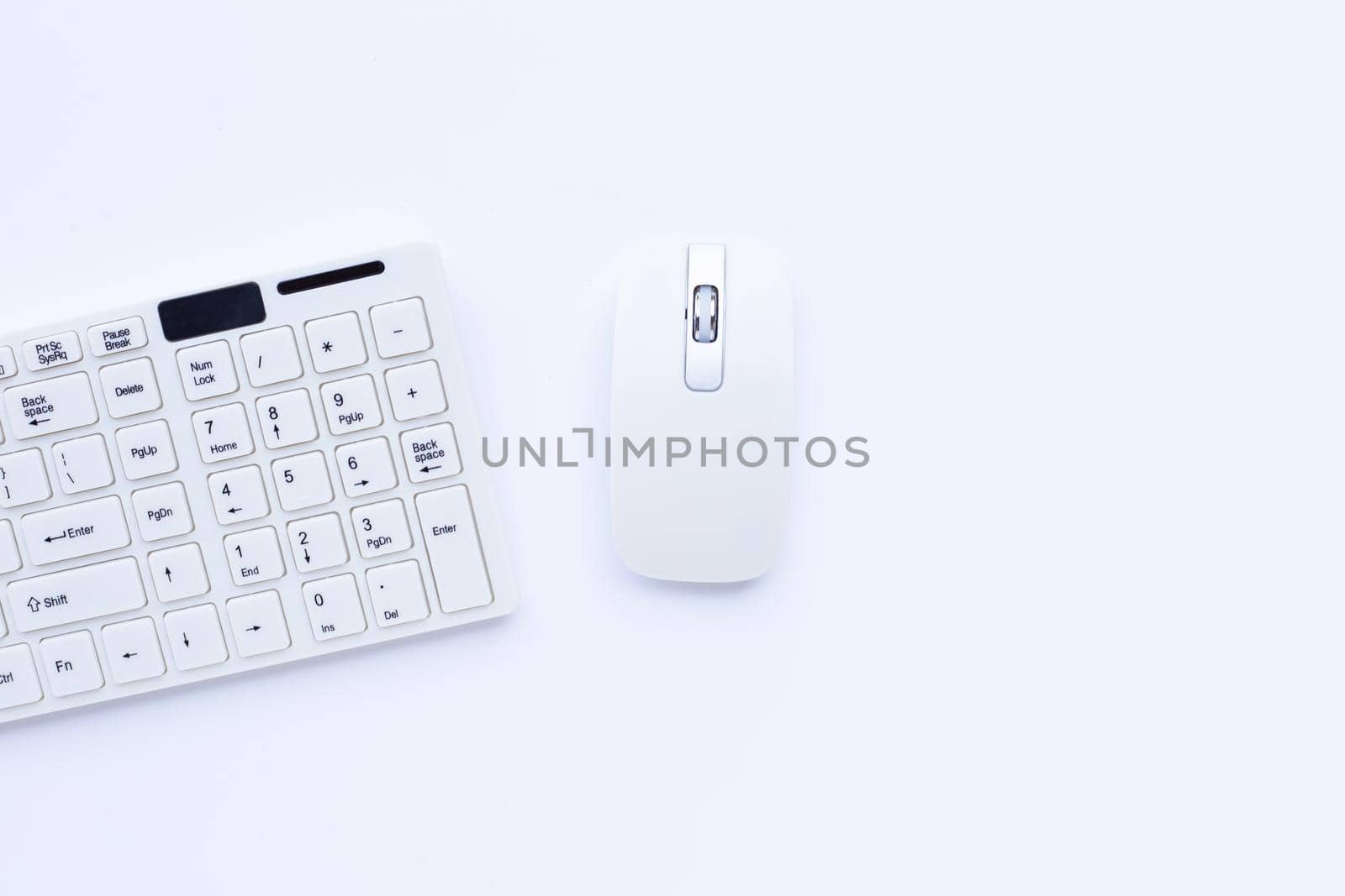 White computer keyboard and mouse on yellow background. Copy space