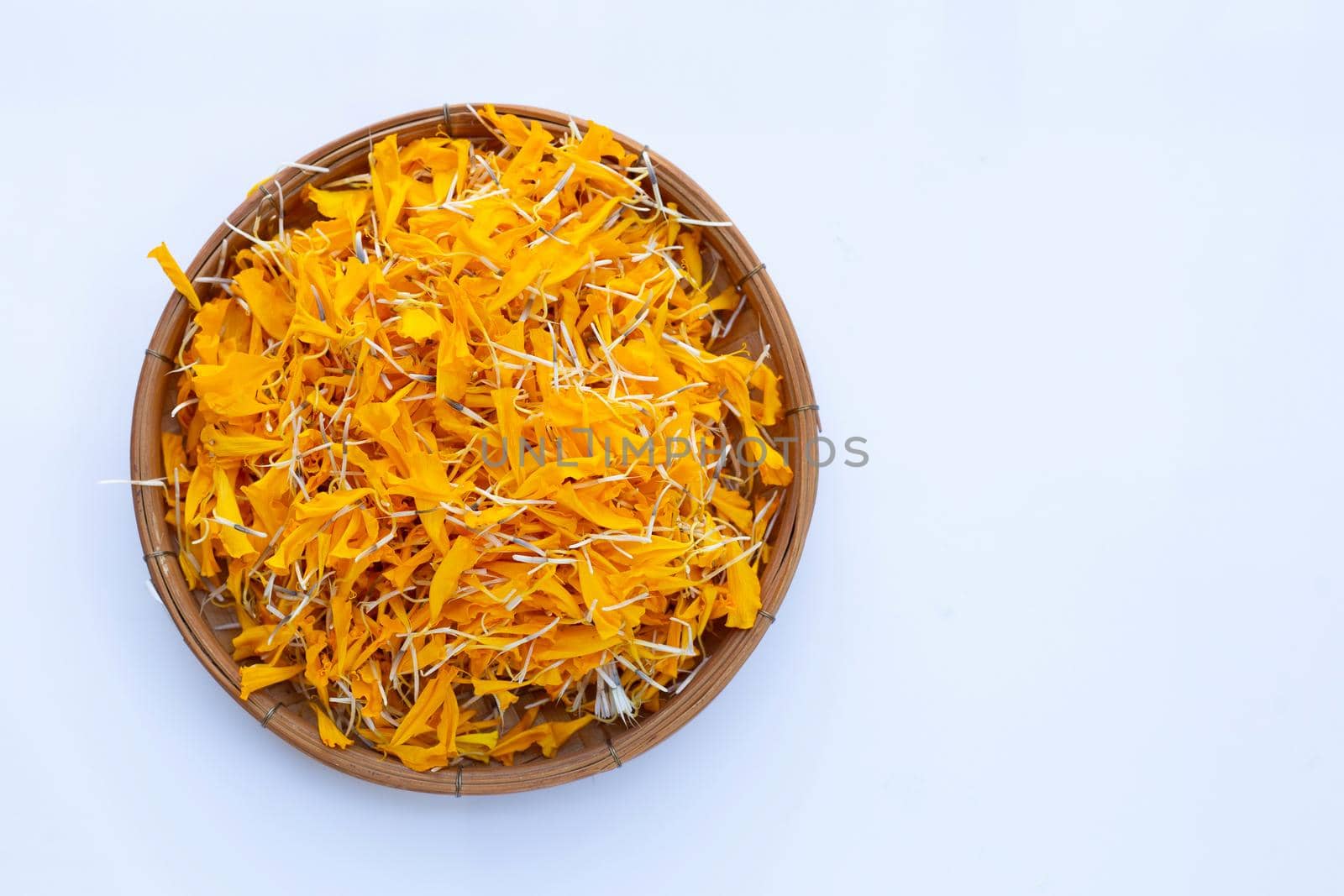Petals of marigold flower on white background.