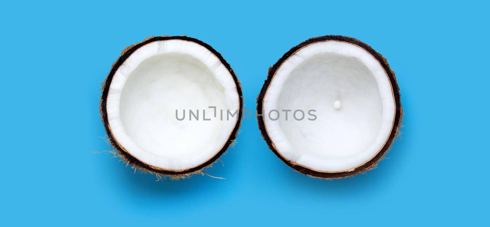 Coconuts on blue background. Copy space by Bowonpat