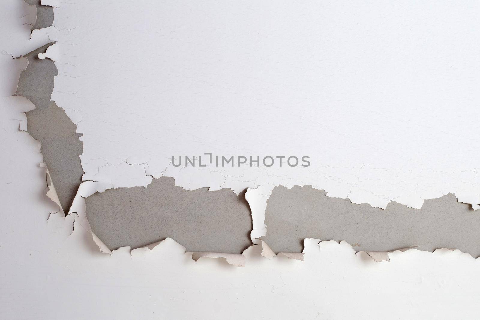 White color paint peeling off on ceiling house. Under the roof