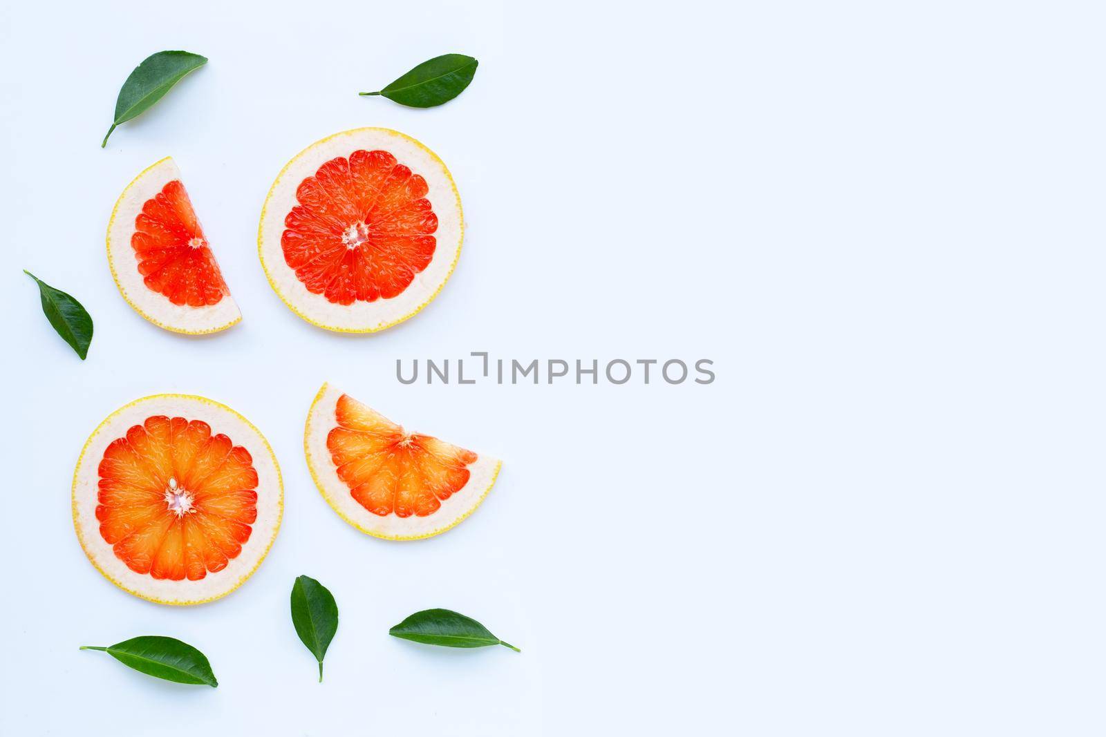High vitamin C. Juicy grapefruit slices on white background.