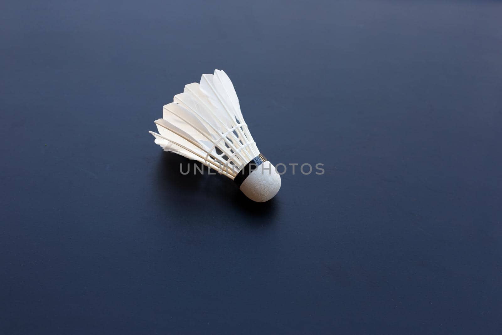 Shuttlecock or badminton ball on dark background.