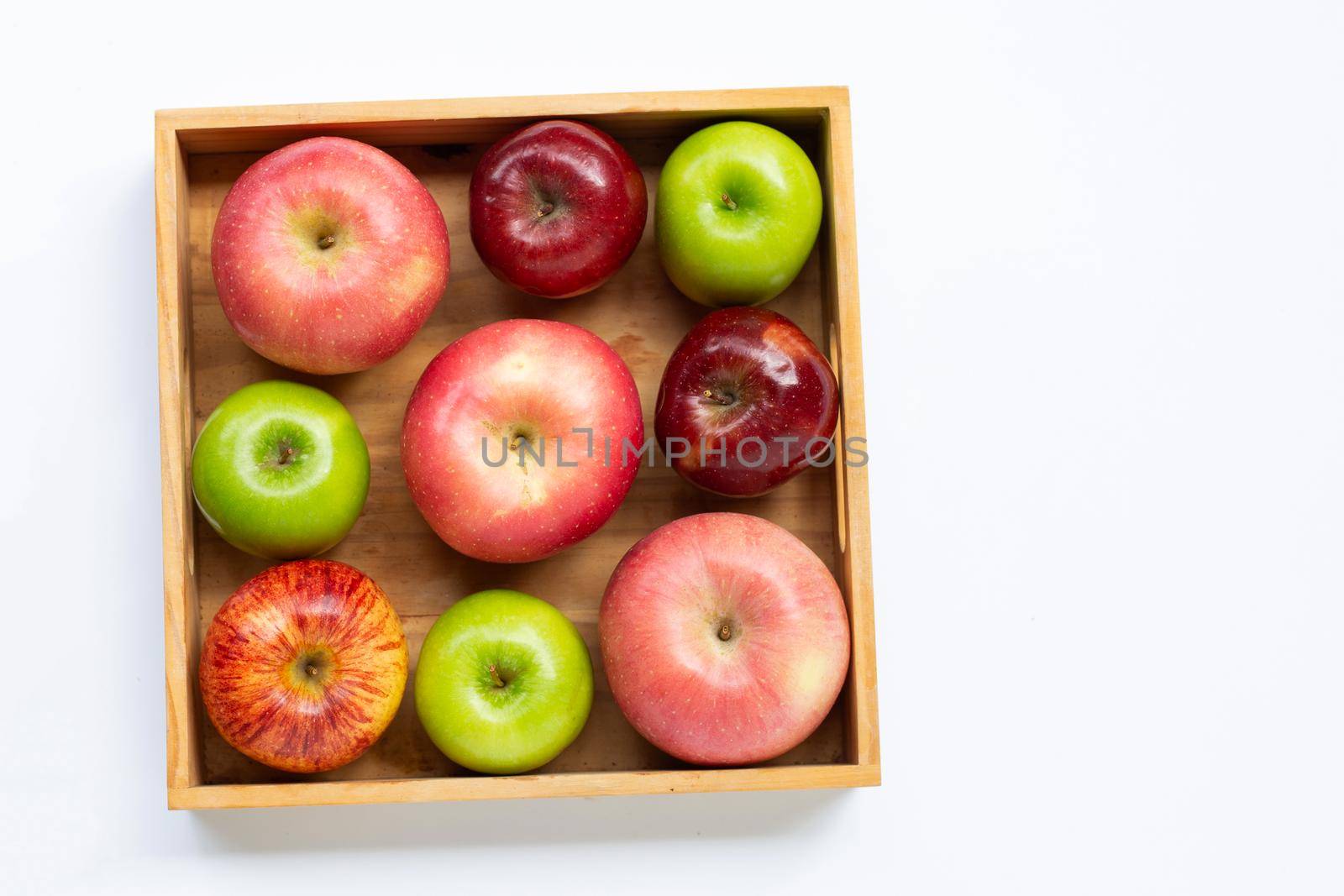 Fresh apples in wooden box on white background.