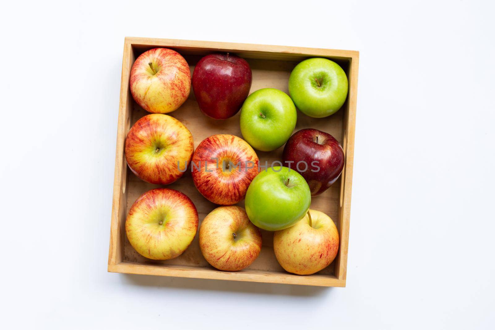 Fresh apples in wooden box on white background.