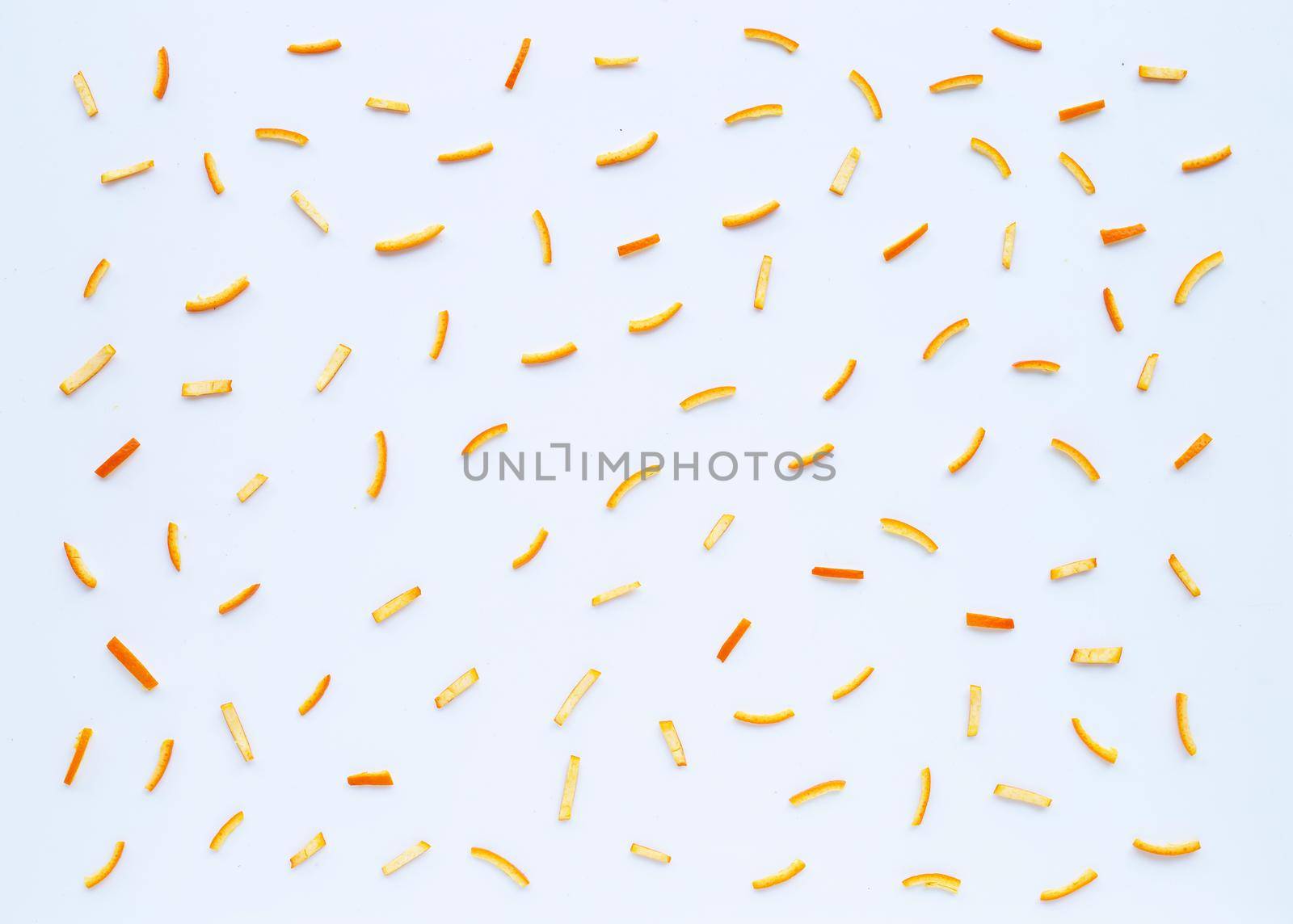 Orange peels on white background. top view