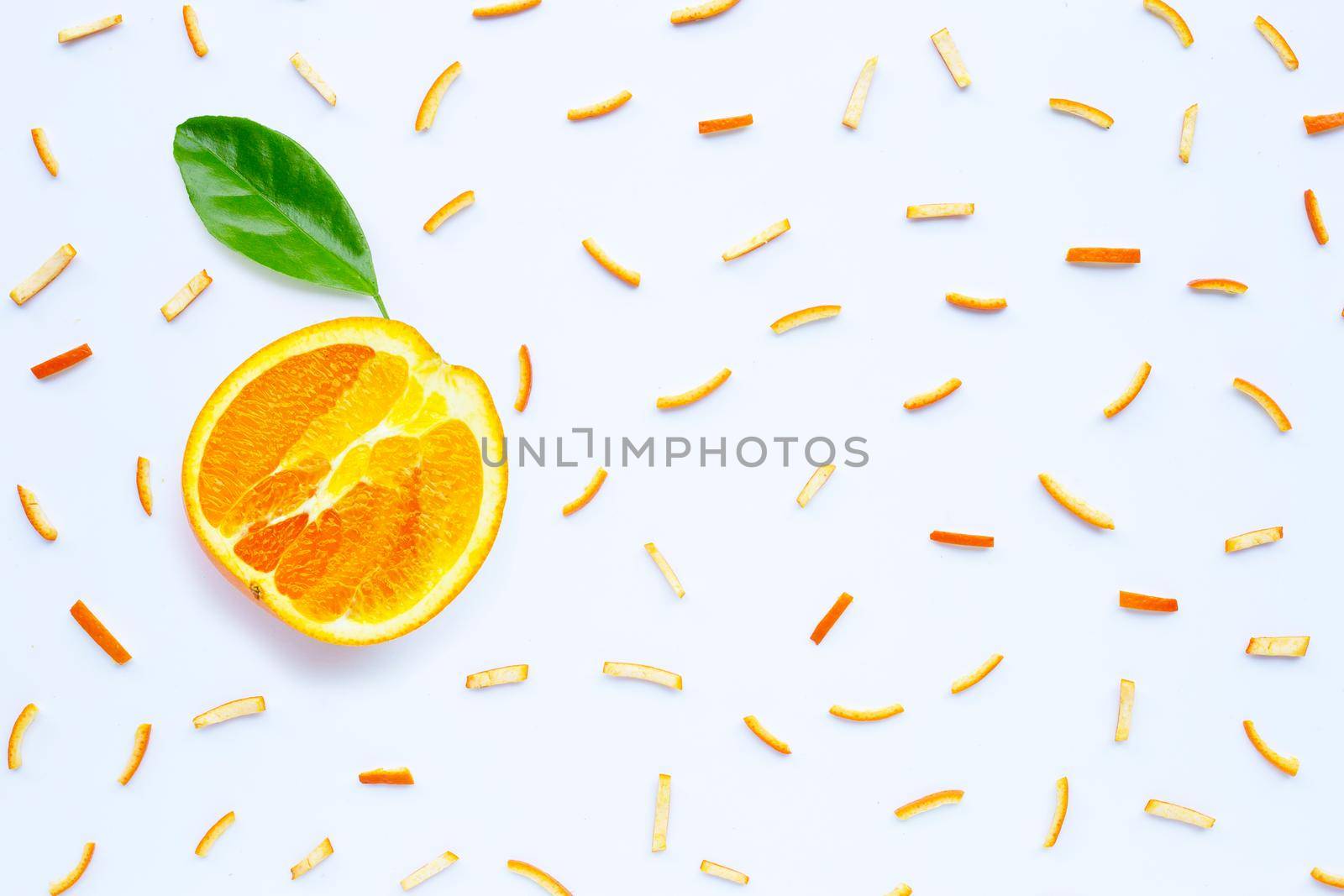 Orange peels on white background. top view