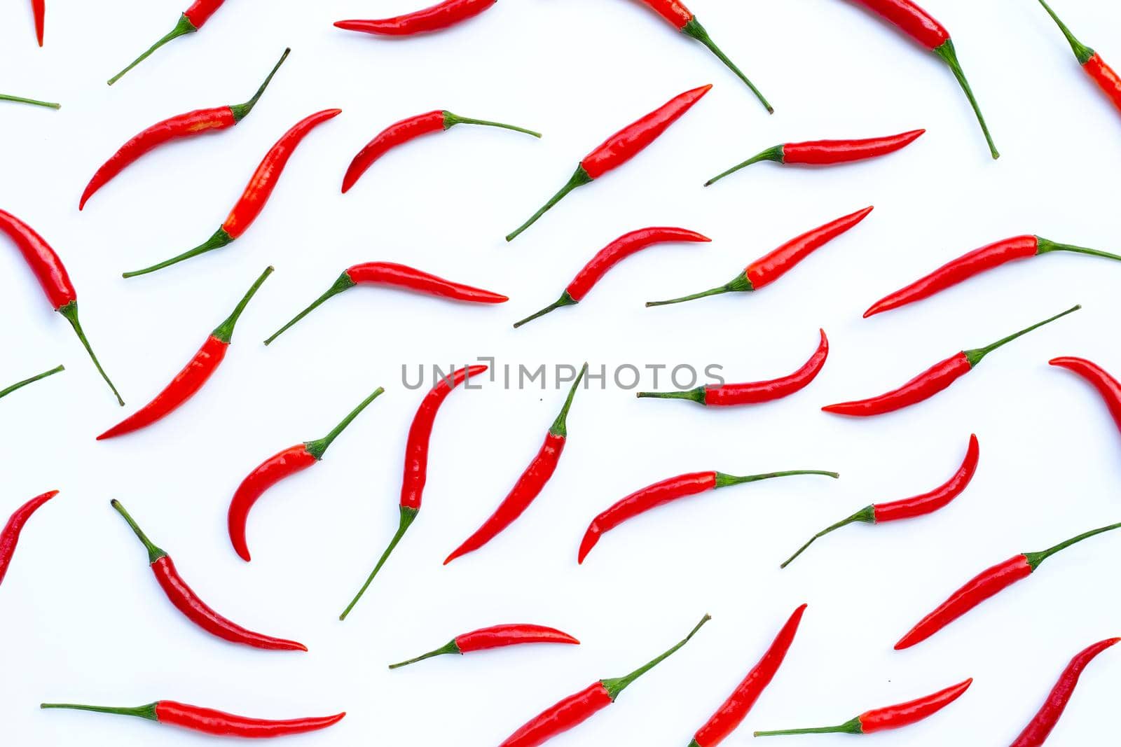 Hot chili peppers on white background. Top view