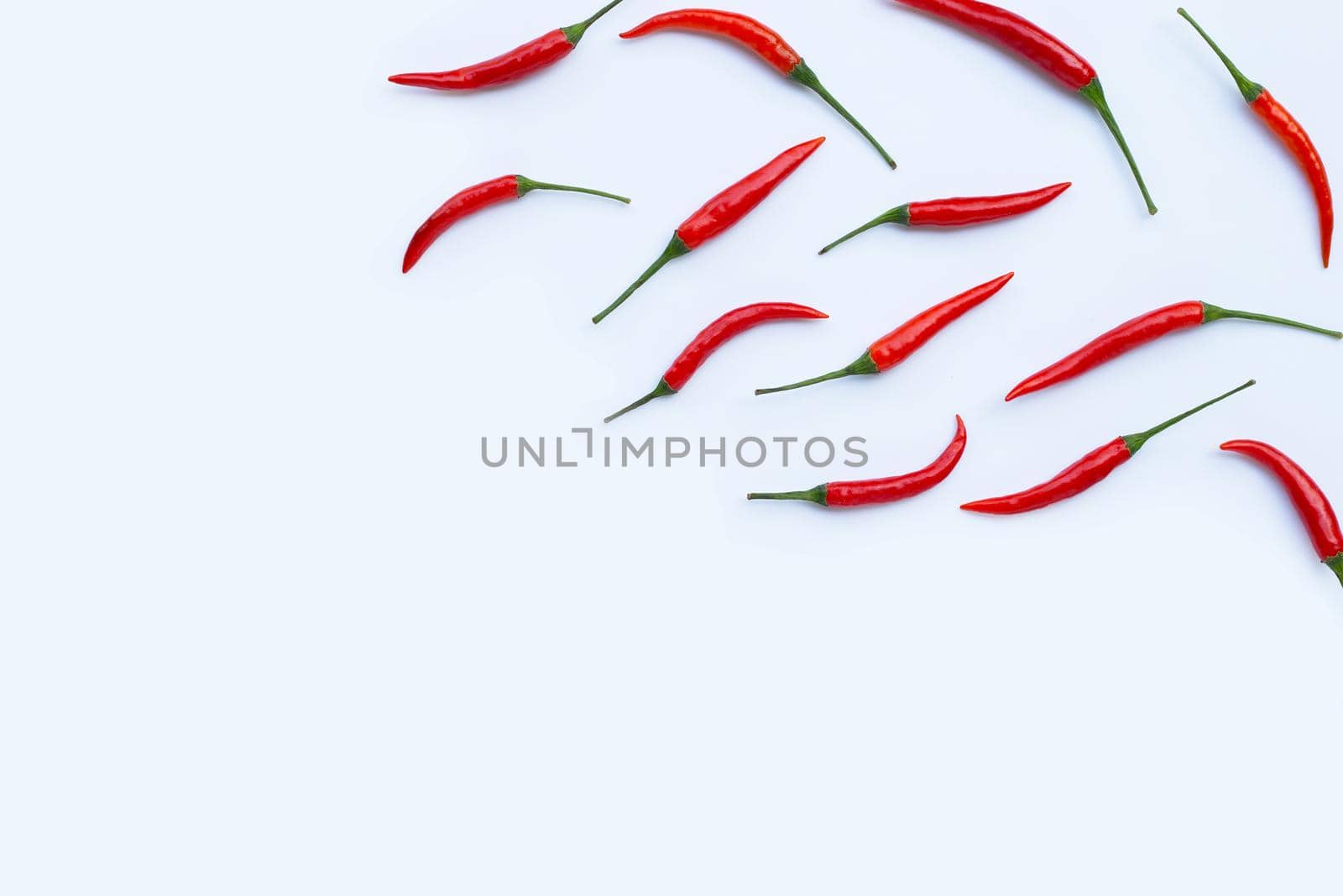 Hot chili peppers on white background. Top view