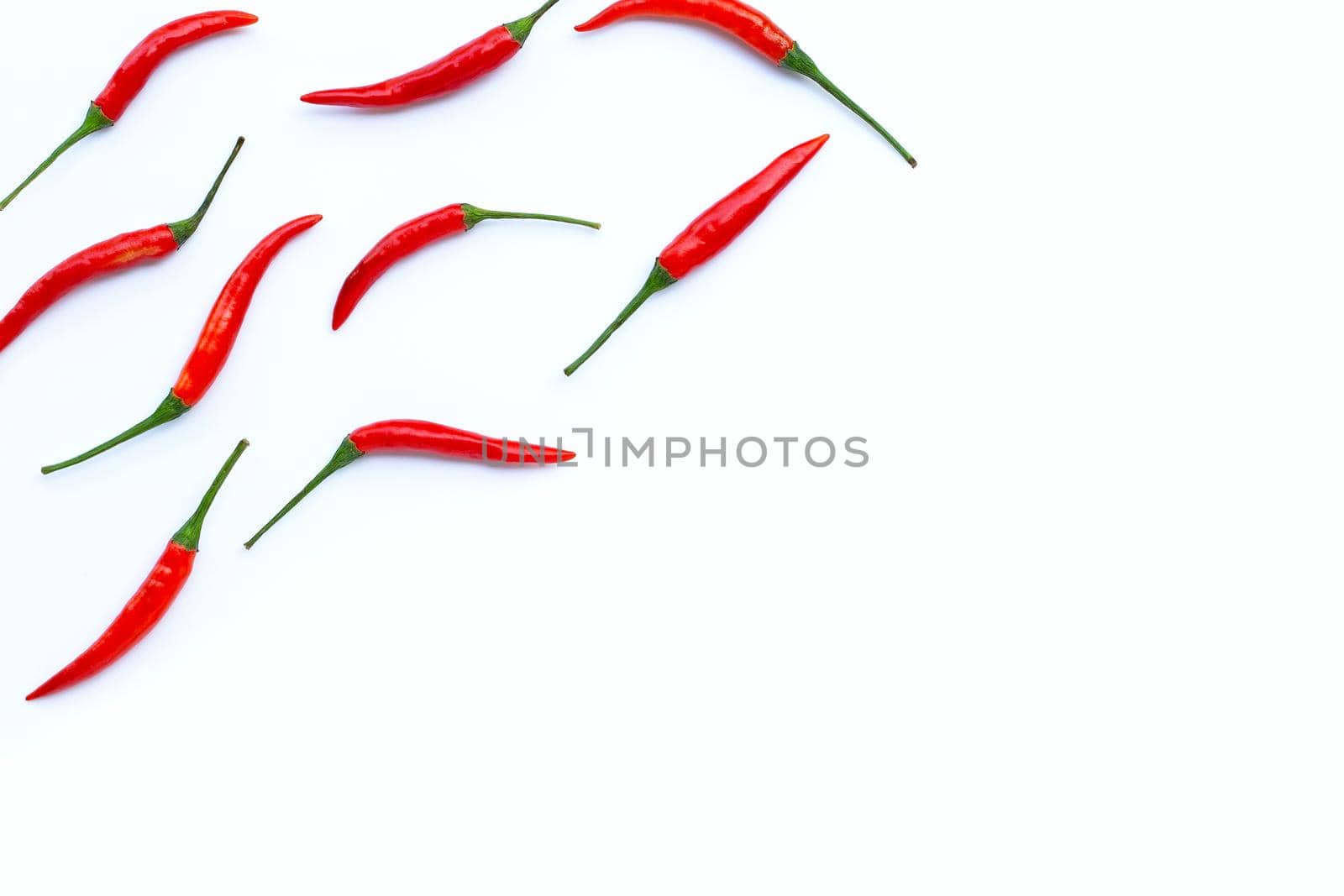 Hot chili peppers on white background. Top view