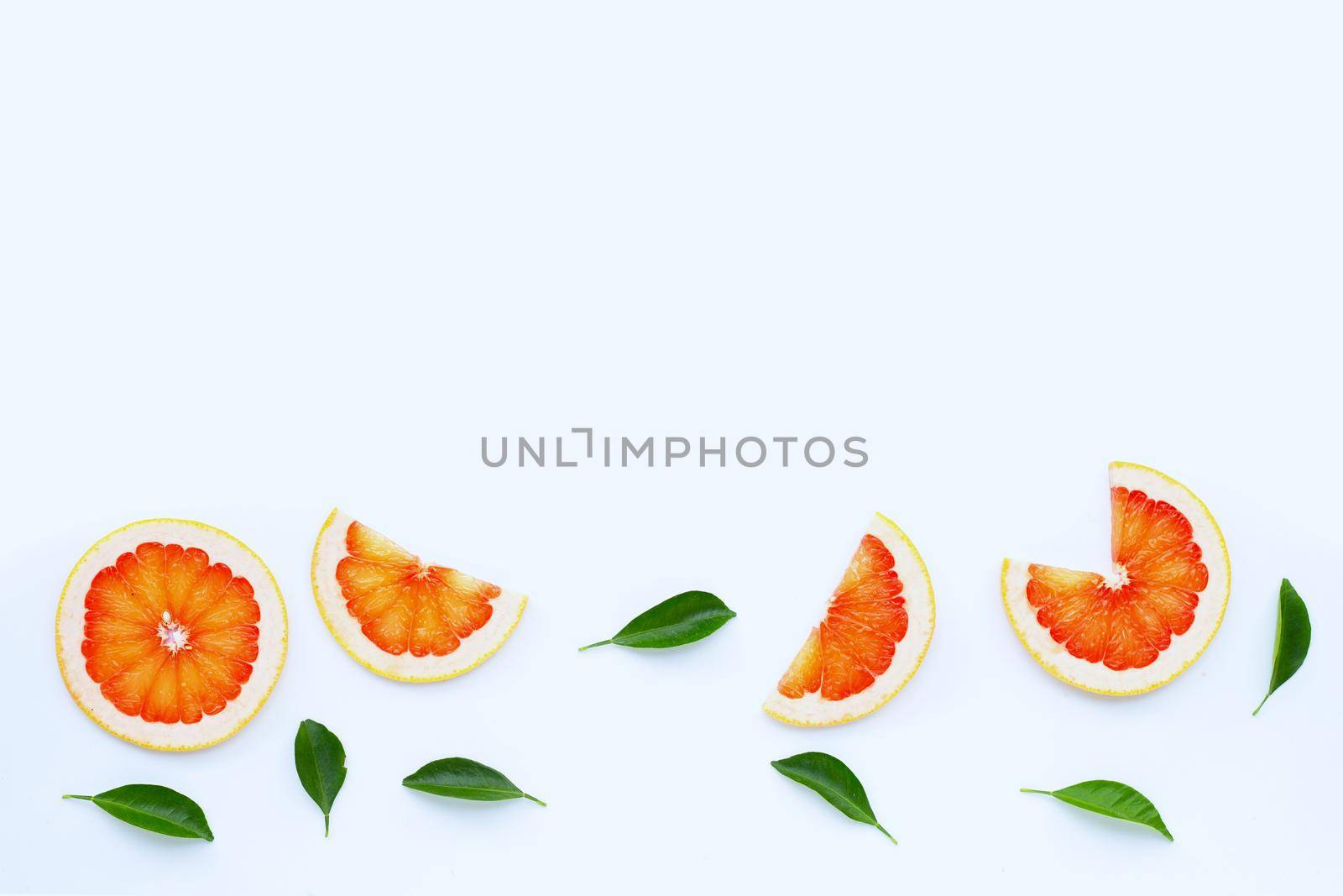 High vitamin C. Juicy grapefruit slices on white background.