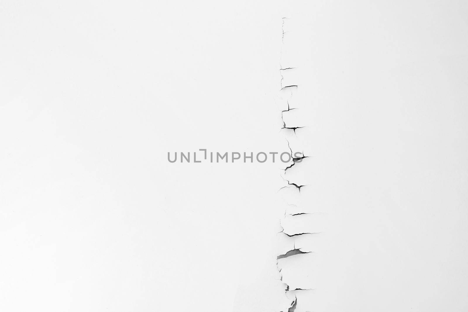 White color paint peeling off on ceiling house. Under the roof