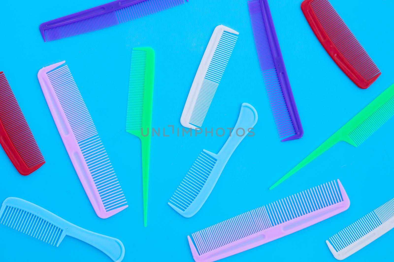 Combs on blue background. Top view