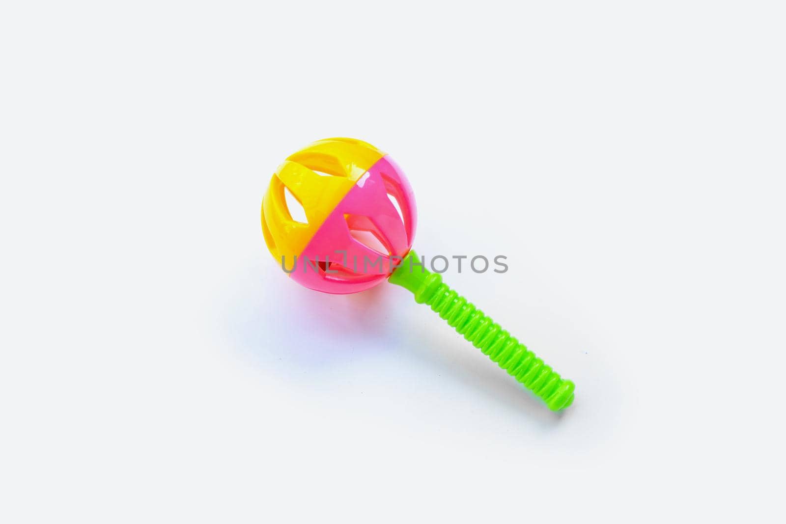 Colorful baby rattle on white background. Copy space