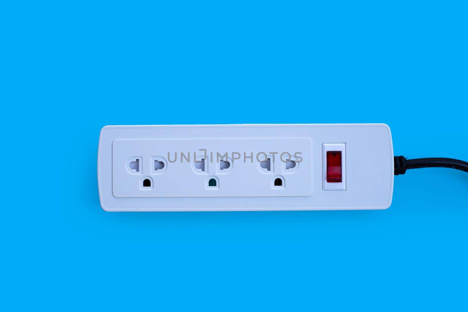 Electrical power strip on blue background. Top view