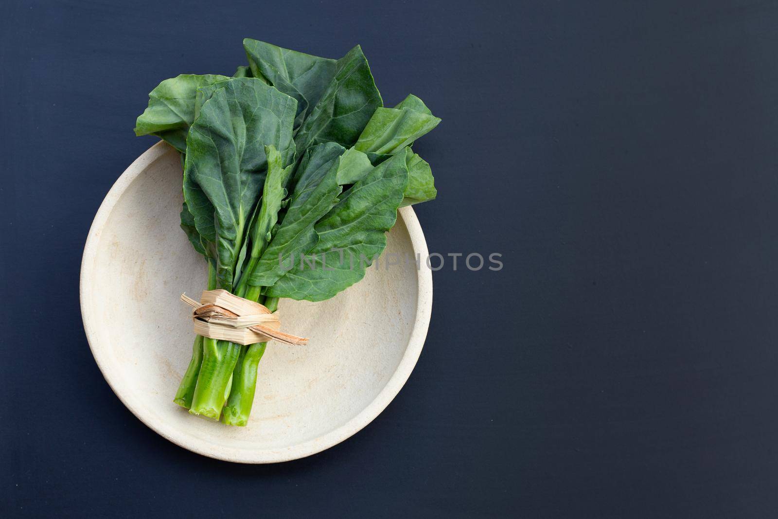 Collard green on dark background. 