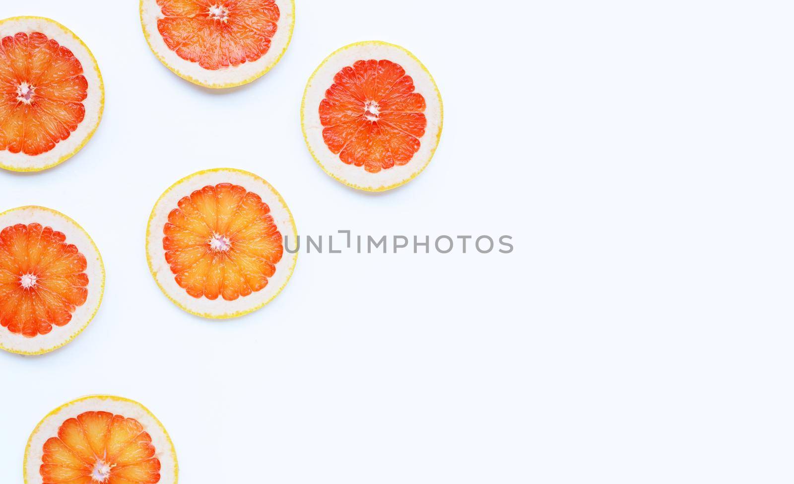 High vitamin C. Juicy grapefruit slices on white background.