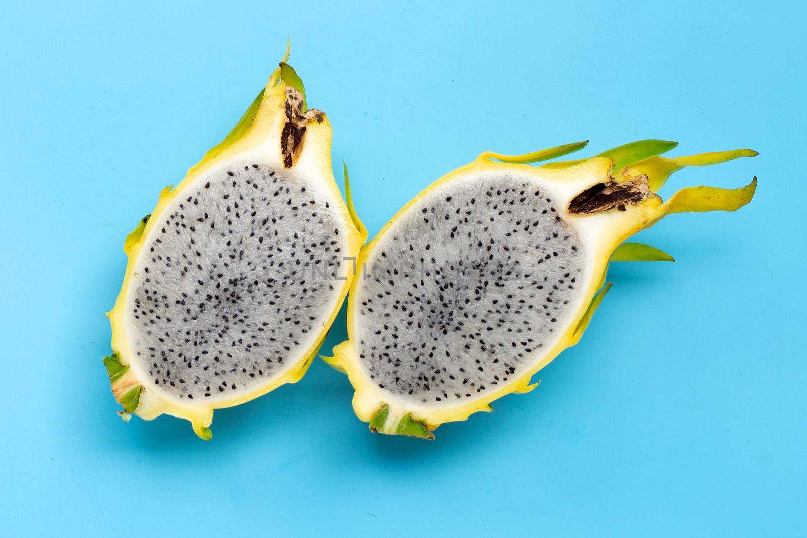 Yellow pitahaya or dragon fruit on blue background.