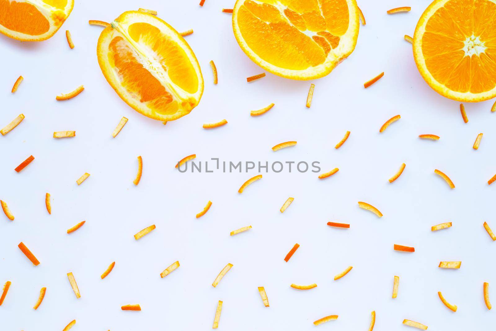 Orange fruit with peels on white background. top view