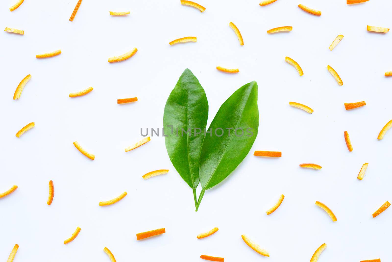 Orange peels leaves on white background. top view