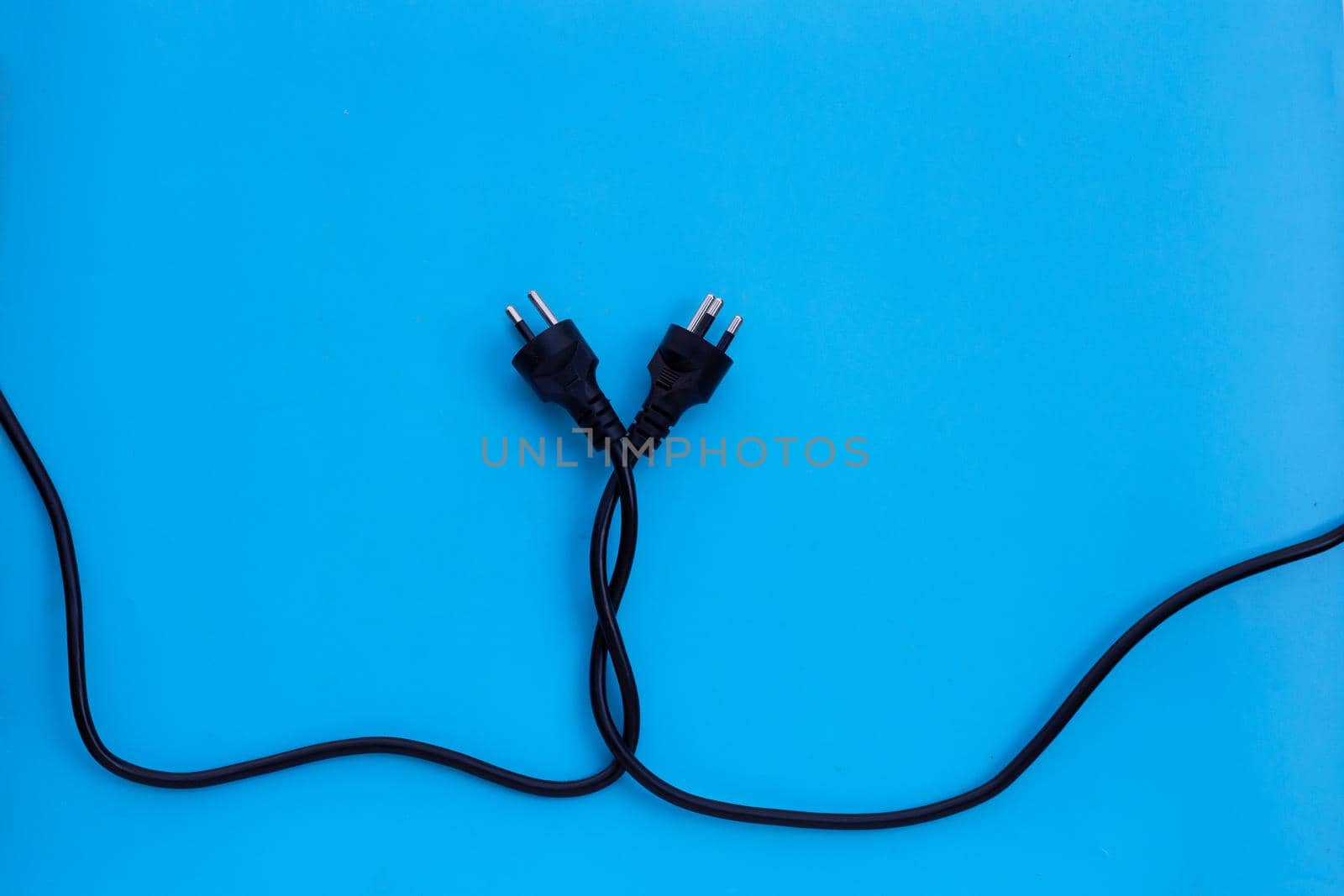 Electric plugs on blue background. Top view