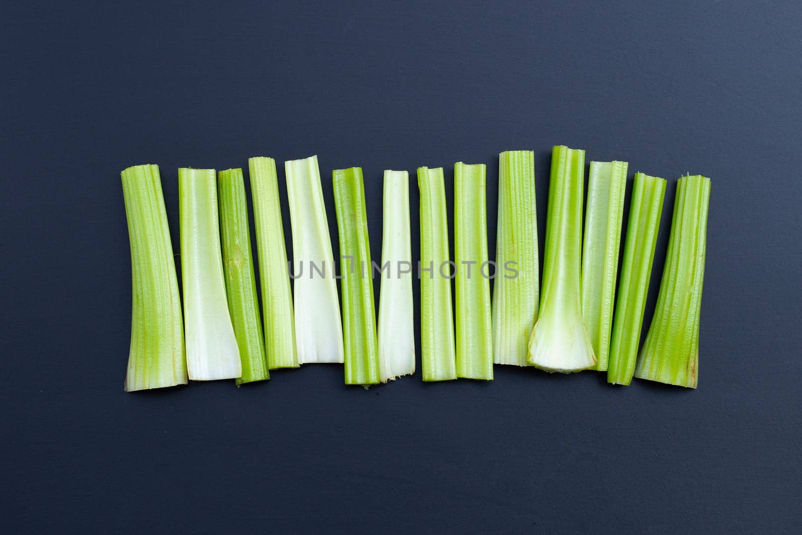 Fresh celery on dark background. Top view