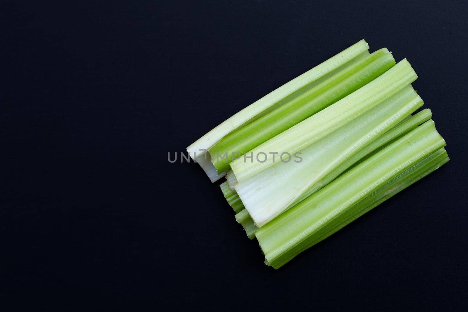 Fresh celery on dark background. Top view