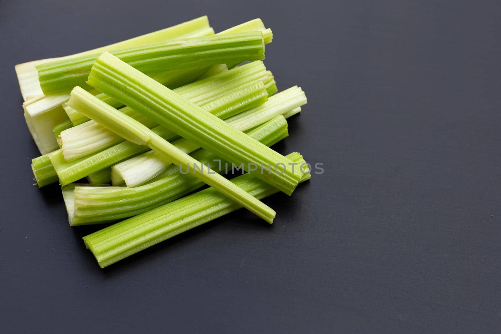 Fresh celery on dark background. Copy space
