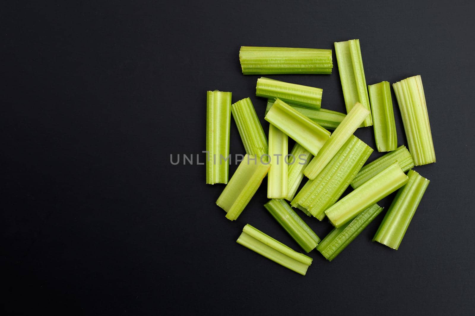 Fresh celery on dark background. Copy space