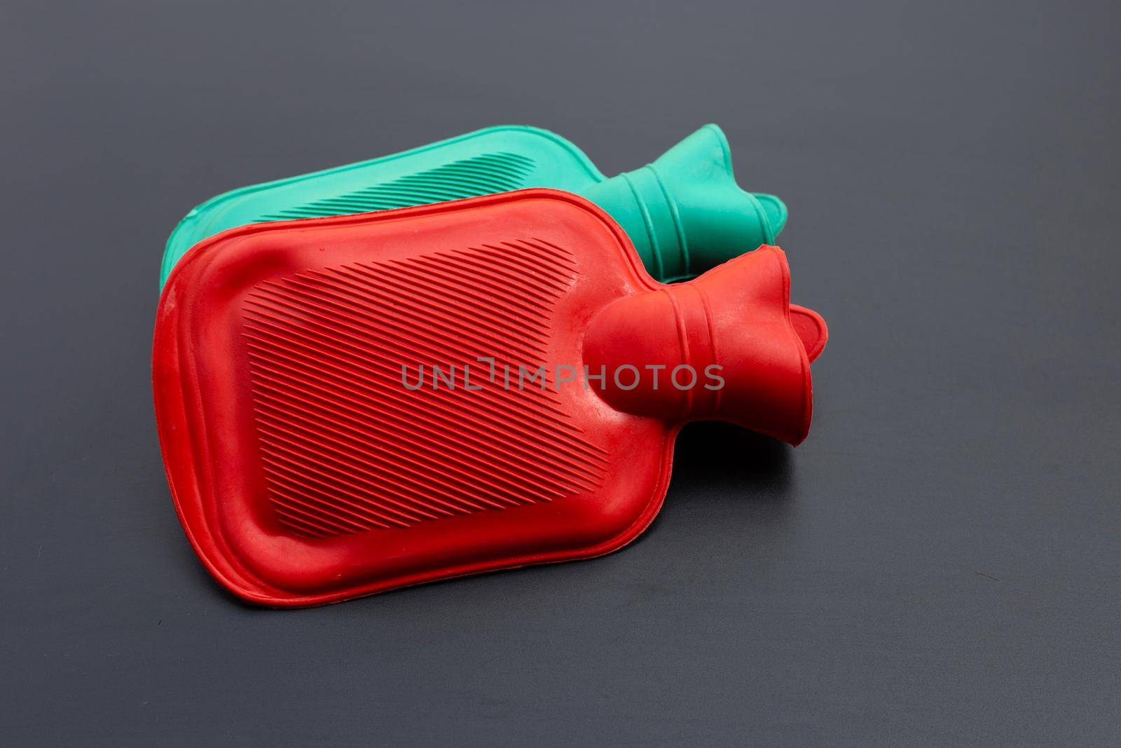 Hot water bags on dark background. Copy space