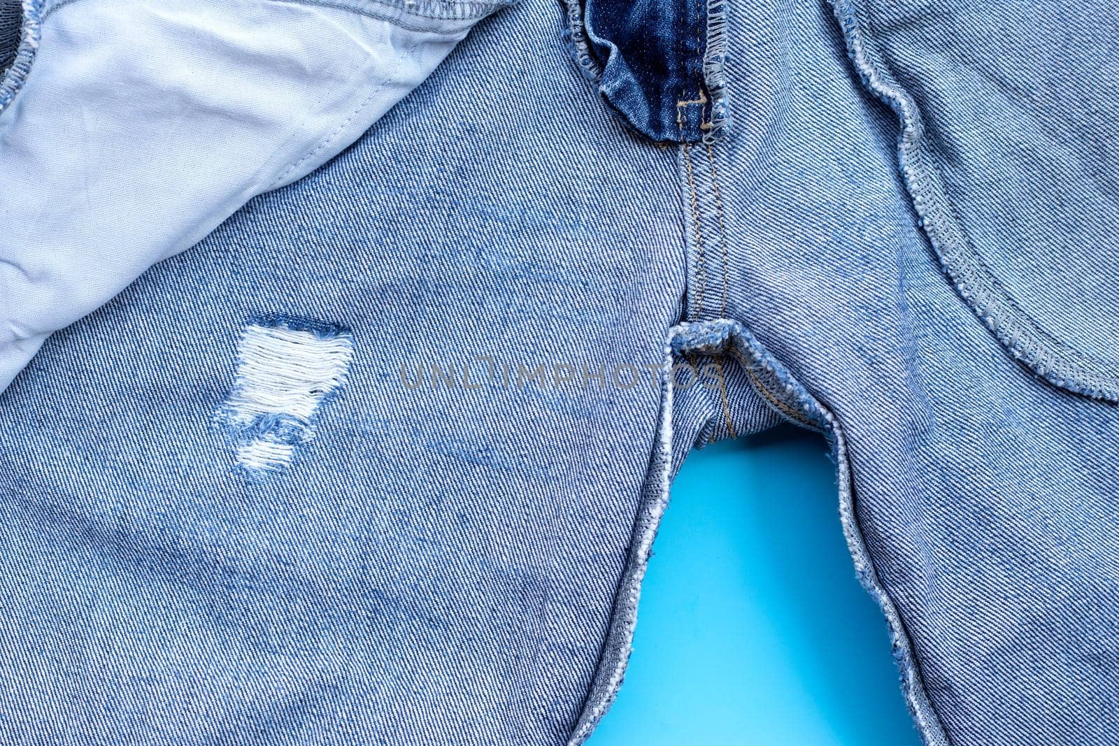 Inside of jeans on blue background. Top view