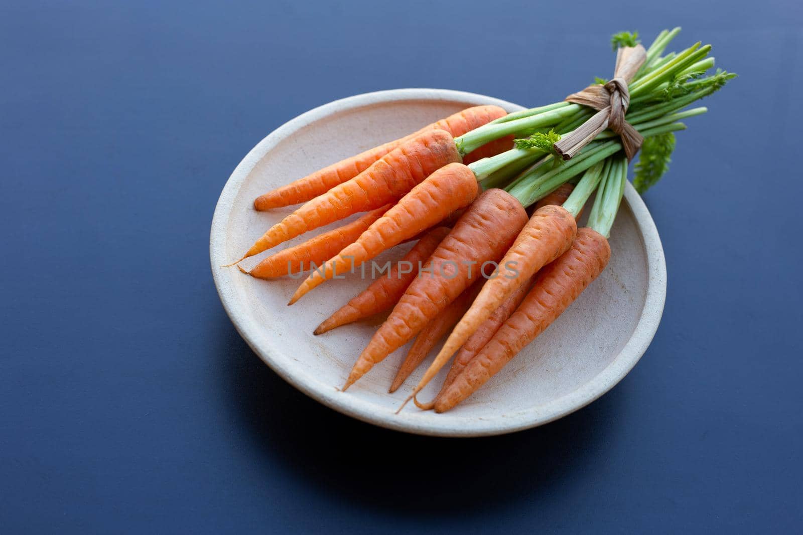 Fresh carrots on dark background.