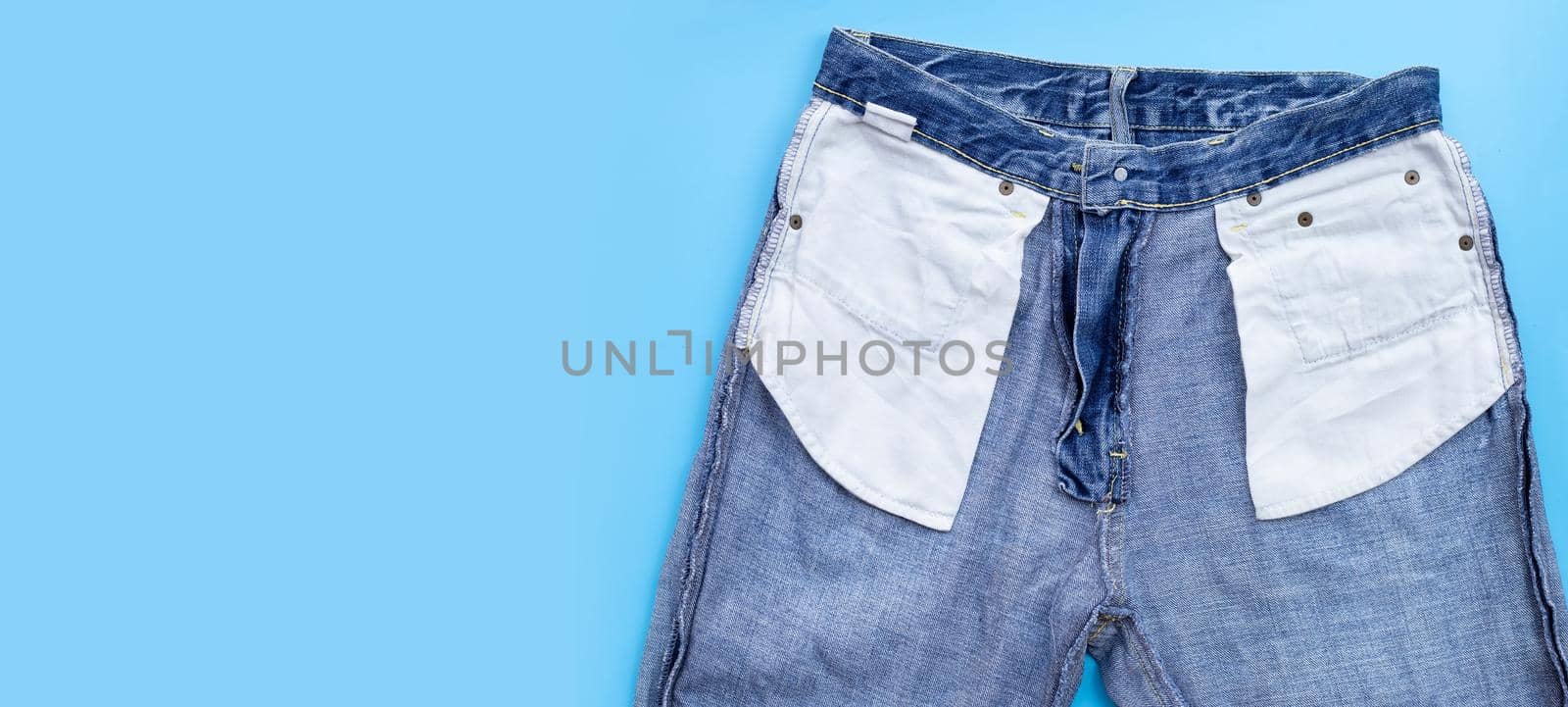 Blue jeans on blue background. by Bowonpat