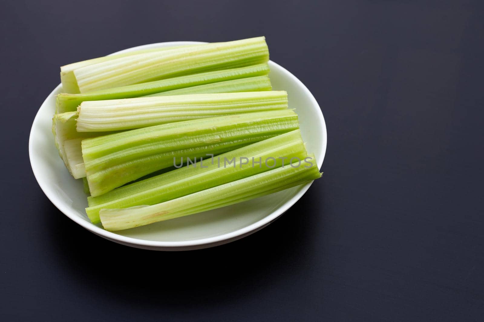Fresh celery on dark background. Copy space