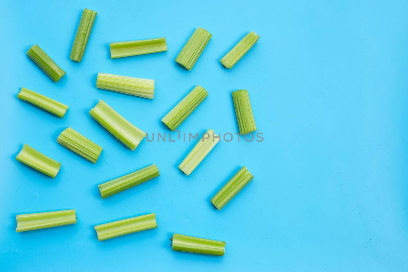 Fresh celery on blue background.