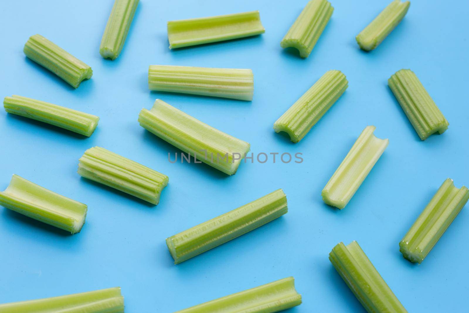 Fresh celery on blue background.