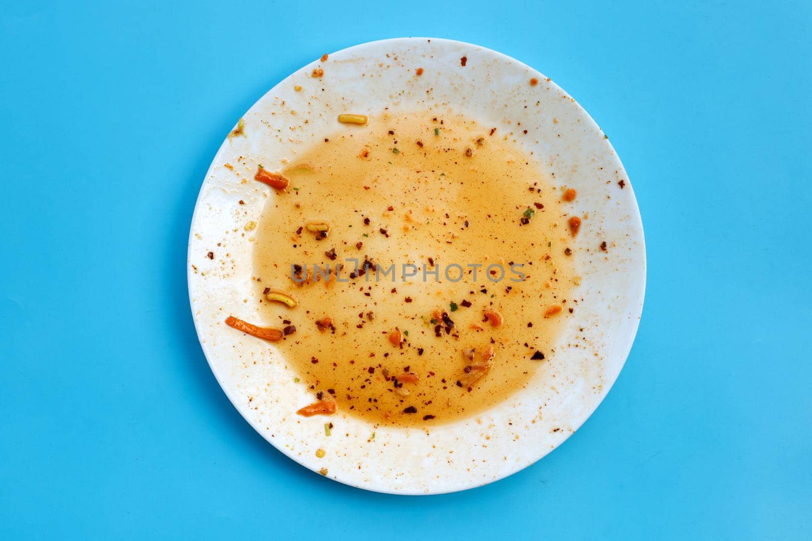 Dirty dish on blue background.