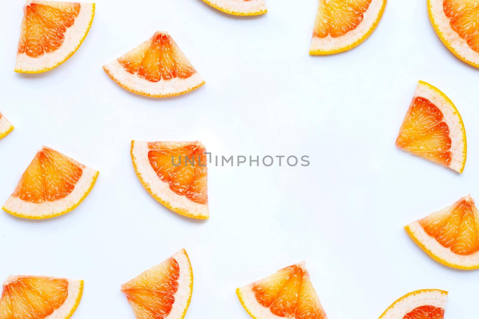High vitamin C. Frame made of Juicy grapefruit slices on white background.
