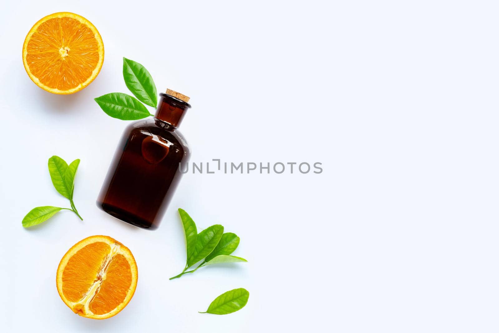 High vitamin C, Fresh orange fruit with essential oil bottle on white background. Copy space