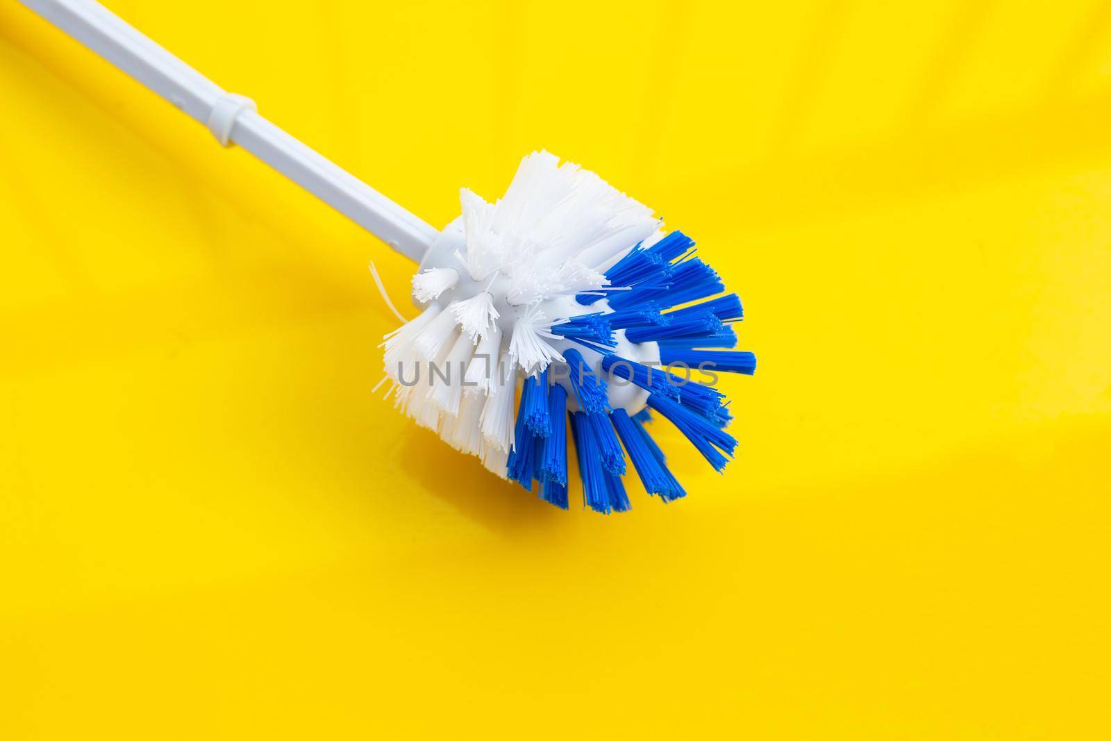 Toilet brush on yellow background. Copy space