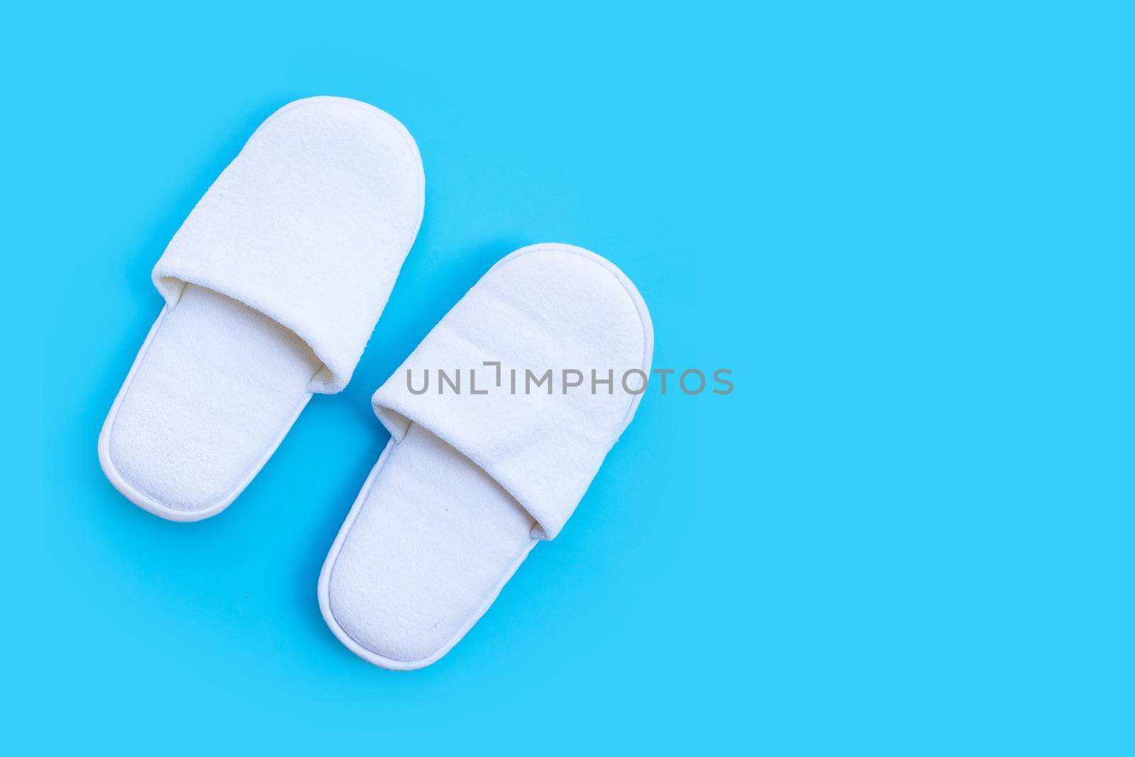 Hotel Slippers on blue background. Copy space