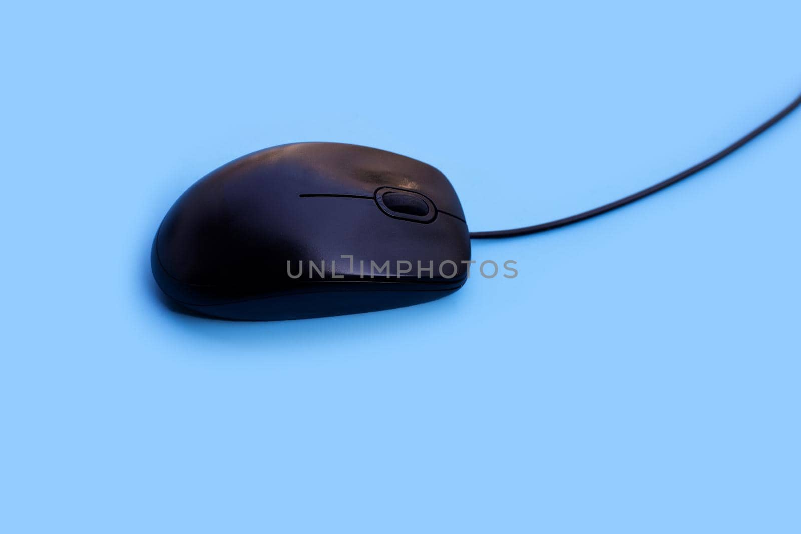 Computer mouse on blue background. Copy space